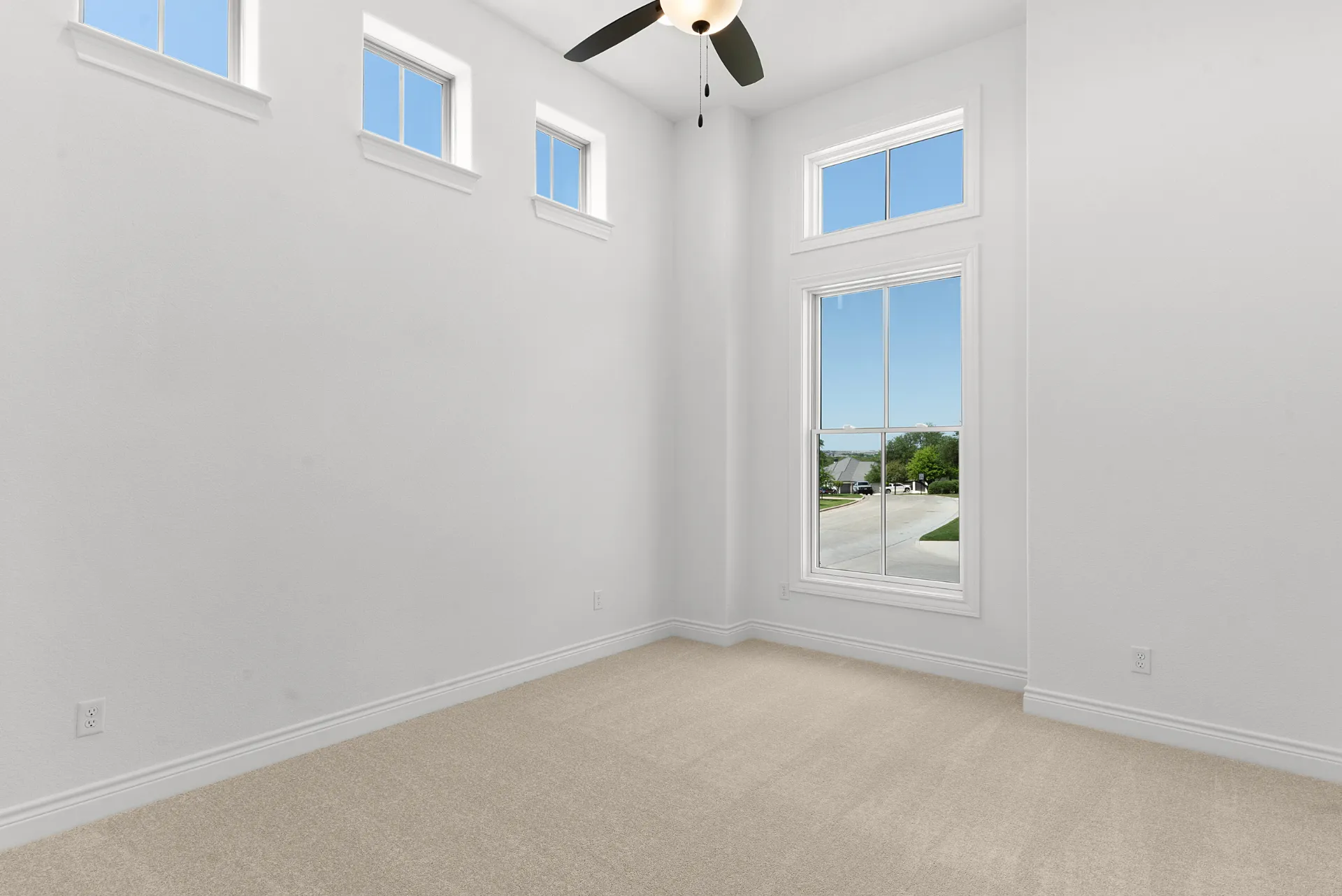Secondary bedroom with vaulted ceiling and clerestory windows