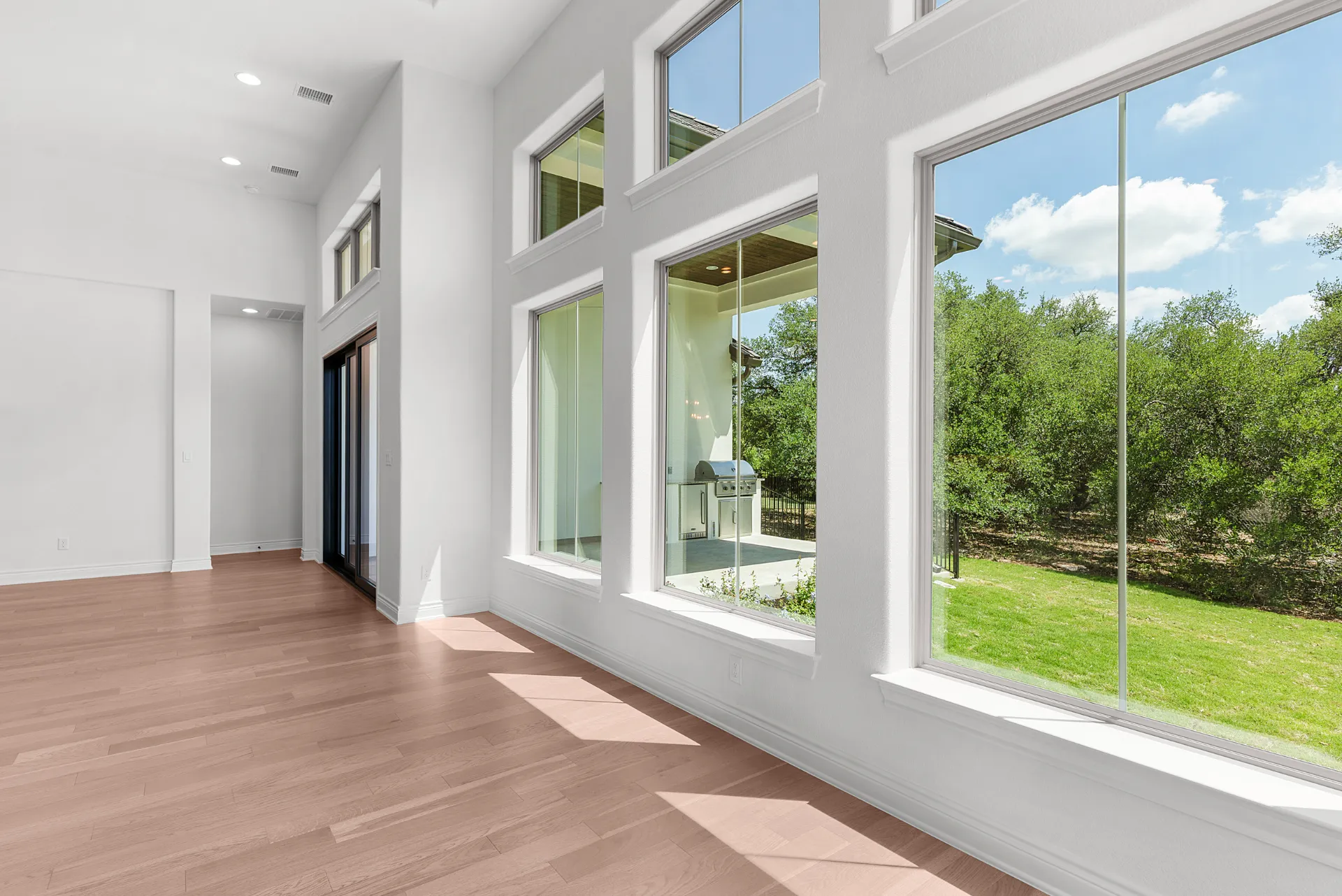 Living area window wall with Hill Country views